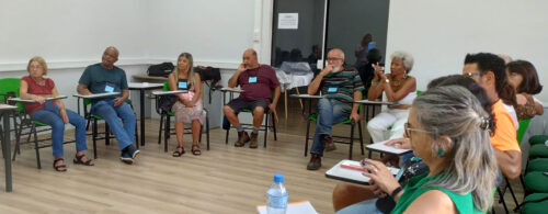 Turma PPA 2024, pessoas sentadas em cadeiras dispostas em círculo durante uma oficina do Programa de Preparação para Aposentadoria
